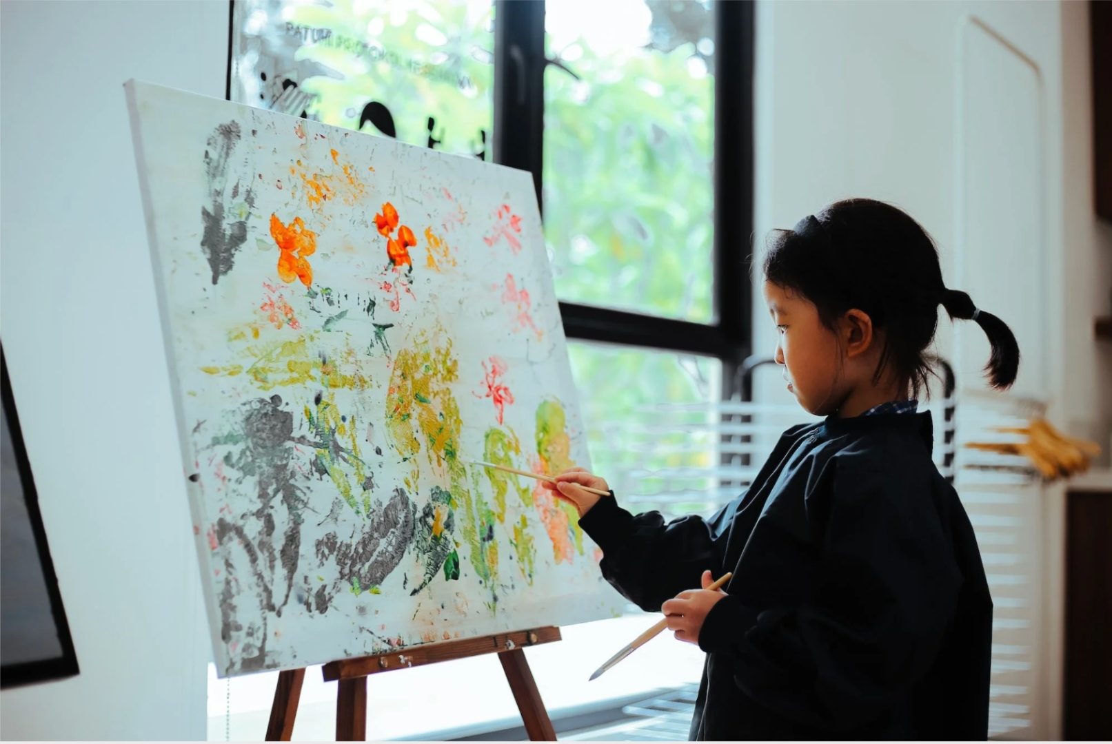 ISJ pupil painting at an easel