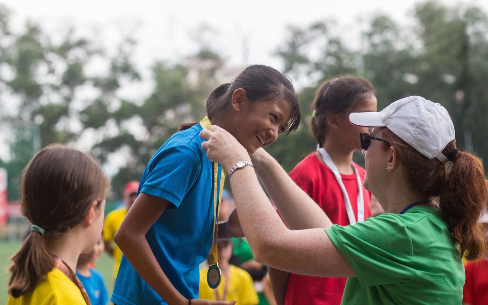 ISJ pupil receiving a medal at a house sports event, house colours visible